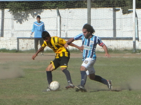 Pablo Olita, capitán de Banco, intenta robarle el esférico a Ezequiel Maciel, el 9 visitante.