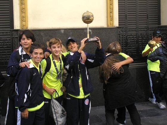 Porta, Santa Clara, Berruti, algunos de los Sub-13 que se bajaron del colectivo mostrando la preciada Copa.